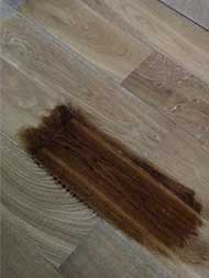 A sample from dark stain on hardwood plank