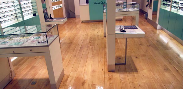 Restoration of the wood floor in a retail unit.